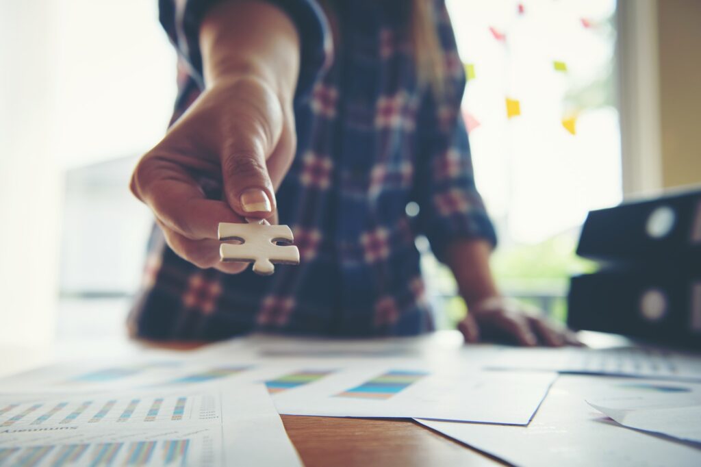 Hand holding jigsaw puzzles, Business partnership concept.